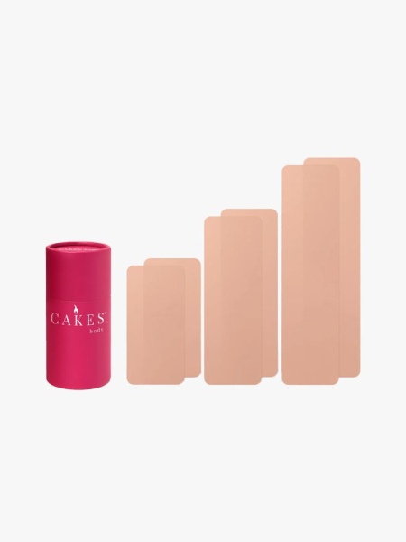 Cakes Tape six strips of boob tape and pink canister on light gray background