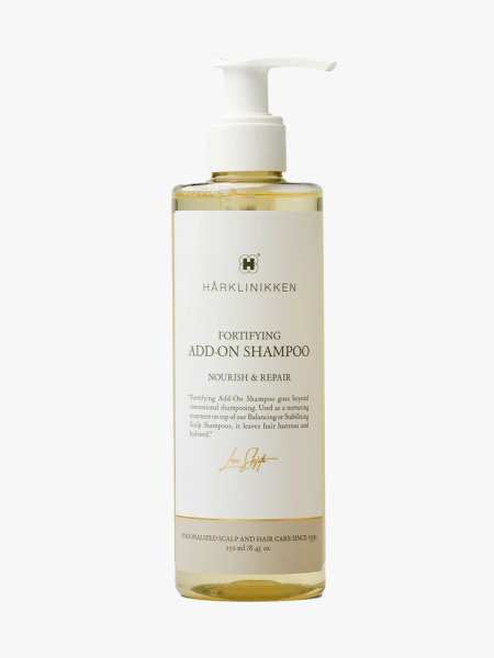Harklinikken Fortifying Shampoo pump bottle of pale yellow shampoo on light gray background